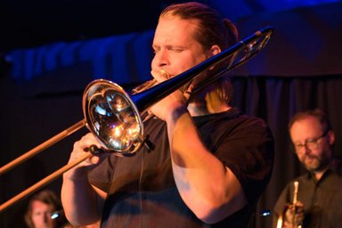 Jan Broder Broge plays a trombone, close-up