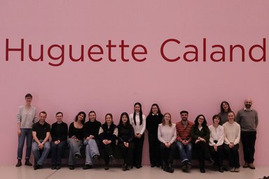 Seminar group stands in front of the Huguette Caland lettering