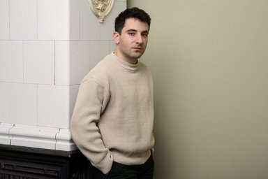 Andrea Scalmana in front of a column