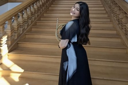 Roxana Mondragon mit Horn auf eine Treppe