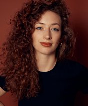 Portrait photo of a woman with reddish curls