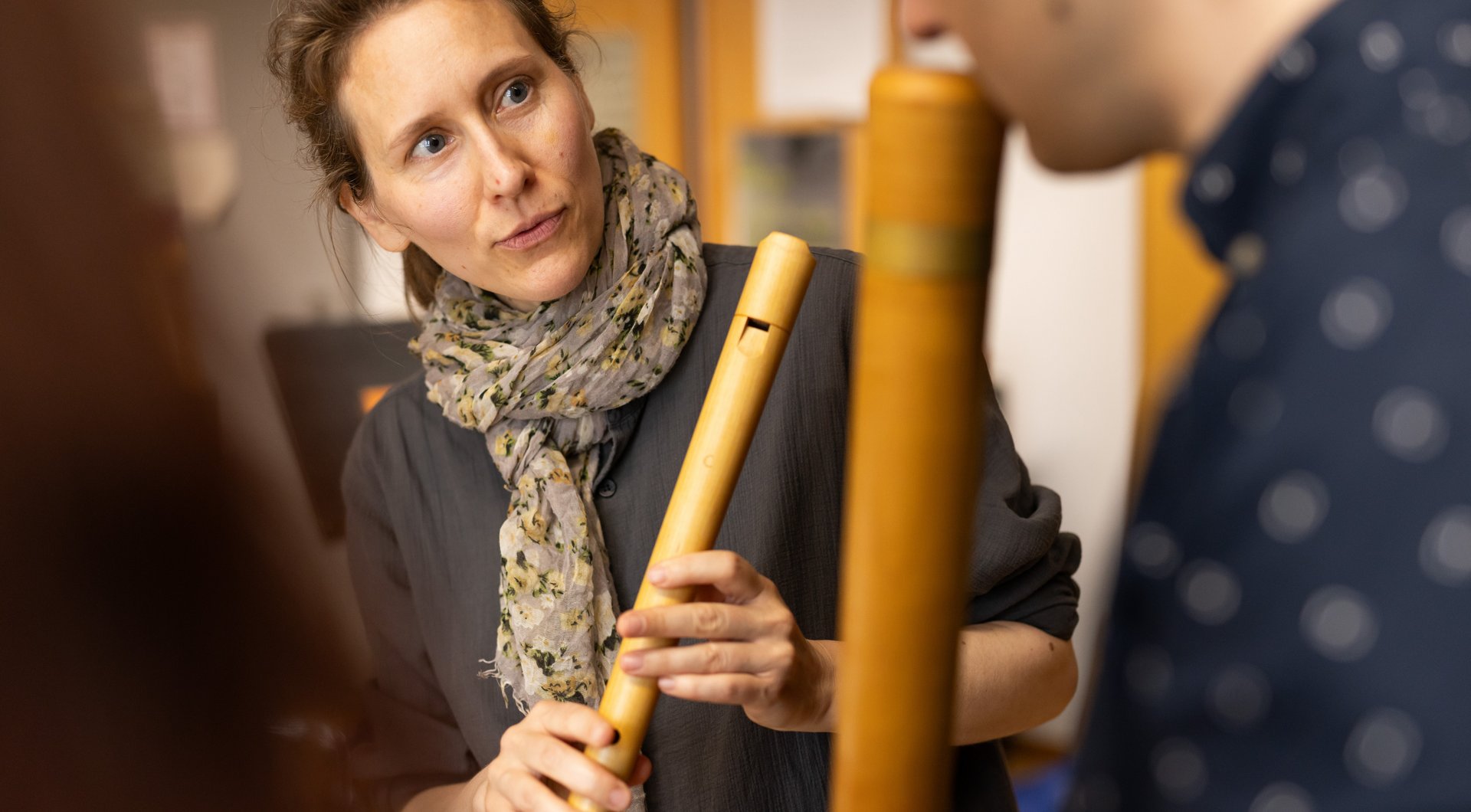 3 people with recorders, concentrated