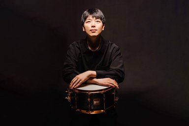 Portrait of a young man with a drum