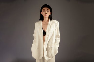 Yue Wu Musician in a white pantsuit