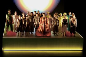 Group of students in colorful costumes on an illuminated stage