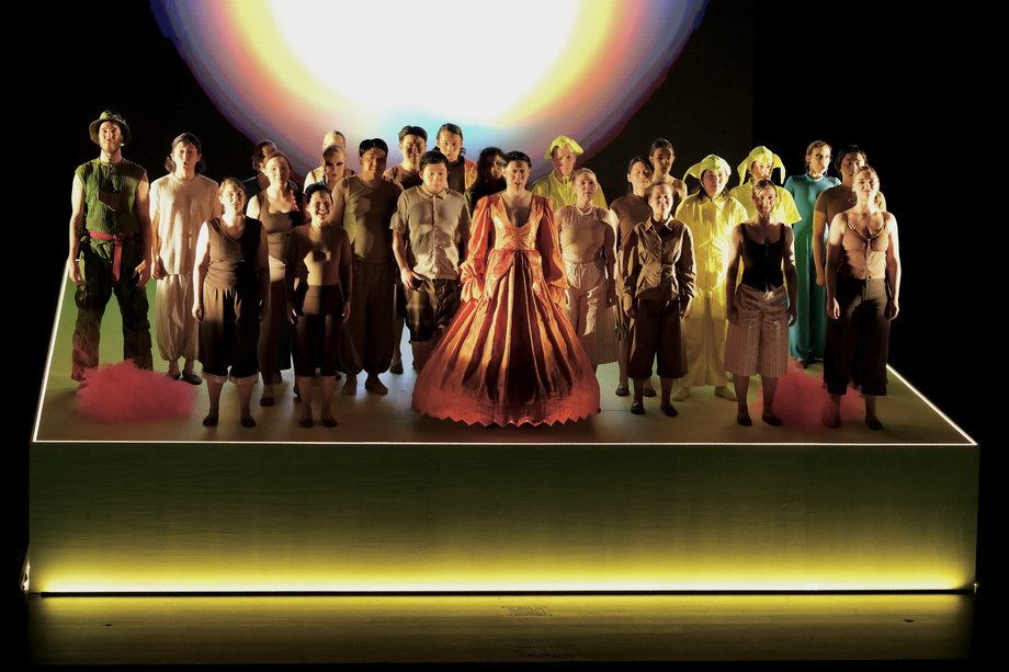 Premiere Magic Flute 2026 Group of students in colorful costumes on an illuminated stage