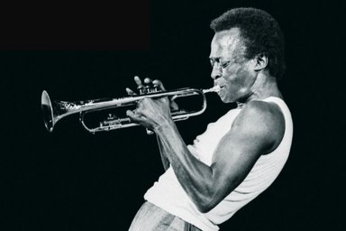Miles Davis during a concert; black and white