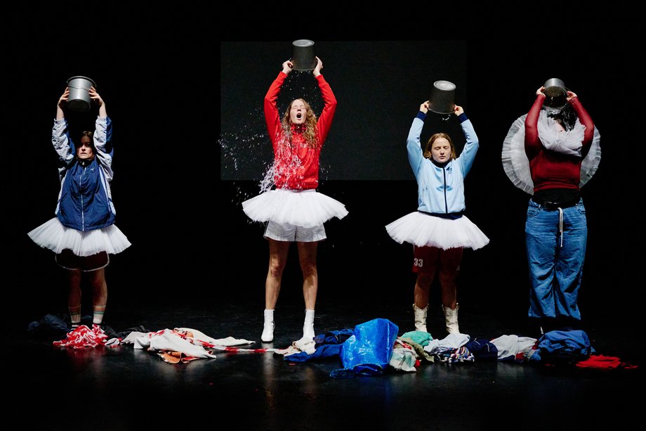 Actresses pouring water over their heads from a bucket